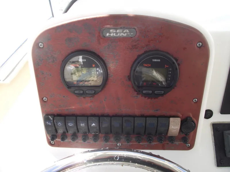 Slide: The Image of Dashboard of 2012 Sea Hunt Ultra 211 boat with gauges and switches. - 22