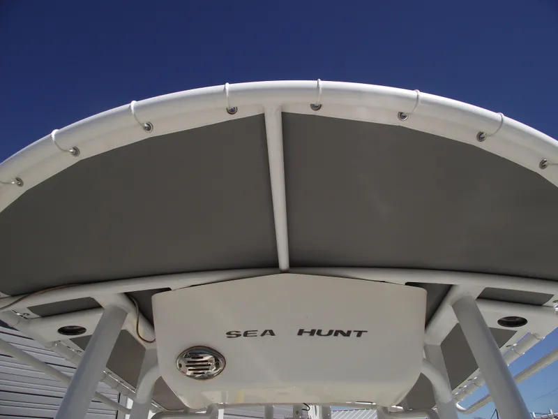 Slide: The Image of 2012 Sea Hunt Ultra 211 boat canopy against clear blue sky. - 23