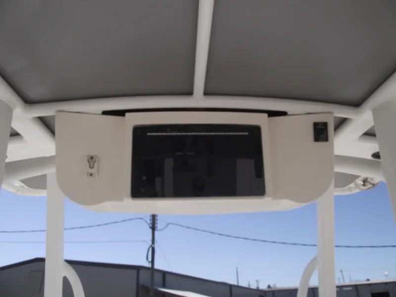 Slide: The Image of 2012 Sea Hunt Ultra 211 boat console with overhead storage and electronics. - 24