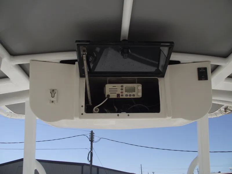 Slide: The Image of 2012 Sea Hunt Ultra 211 boat console with radio and storage compartment. - 25