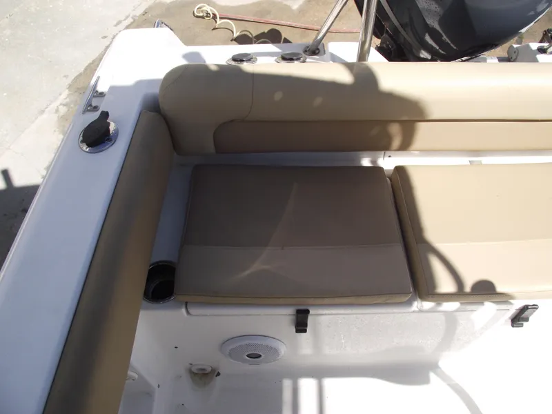 Slide: The Image of 2012 Sea Hunt Ultra 211 boat interior with beige seating and cup holders. - 31