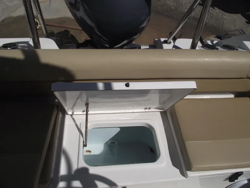 Slide: The Image of 2012 Sea Hunt Ultra 211 boat with open storage compartment and beige seating. - 36