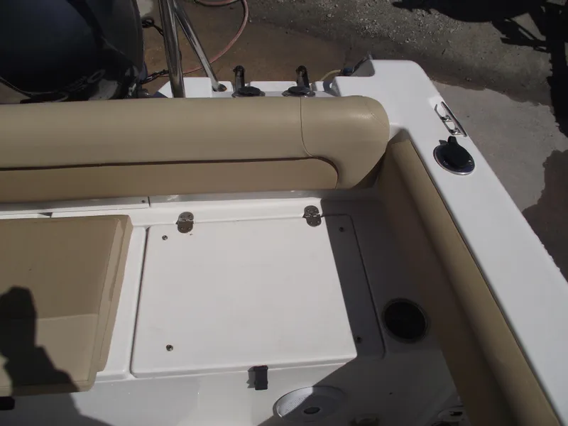 Slide: The Image of 2012 Sea Hunt Ultra 211 boat interior with beige seating and storage compartment. - 38