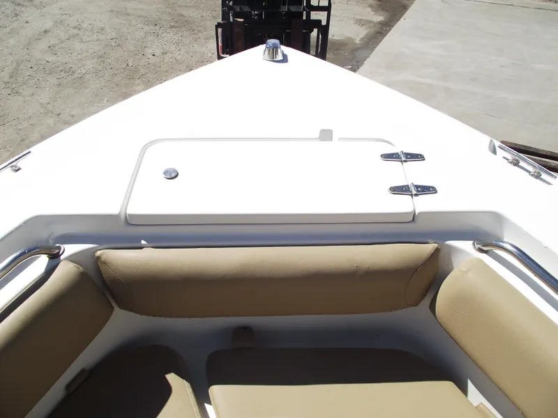 Slide: The Image of 2012 Sea Hunt Ultra 211 boat bow with cushioned seating and storage compartment. - 4