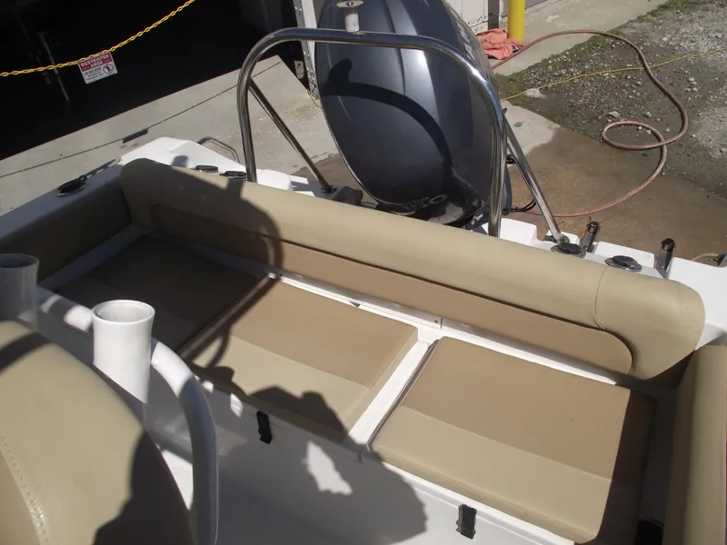 Slide: The Image of 2012 Sea Hunt Ultra 211 boat interior with beige seating and stainless steel railing. - 40