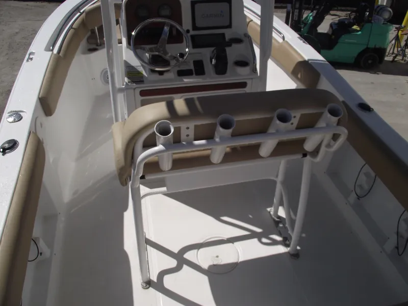 Slide: The Image of 2012 Sea Hunt Ultra 211 boat interior with steering console and rod holders. - 41