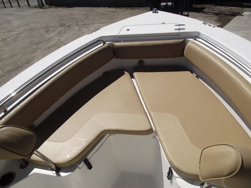 Slide: The Image of 2012 Sea Hunt Ultra 211 boat with tan cushioned seating in the bow area. - 6