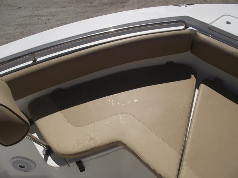 Slide: The Image of 2012 Sea Hunt Ultra 211 boat with beige cushioned seating area. - 7