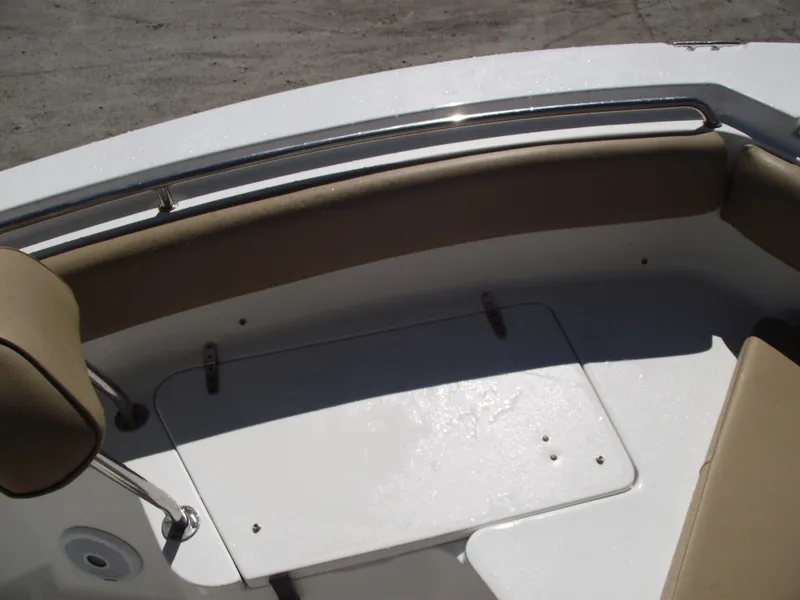 Slide: The Image of 2012 Sea Hunt Ultra 211 boat interior with cushioned seating and storage compartment. - 8