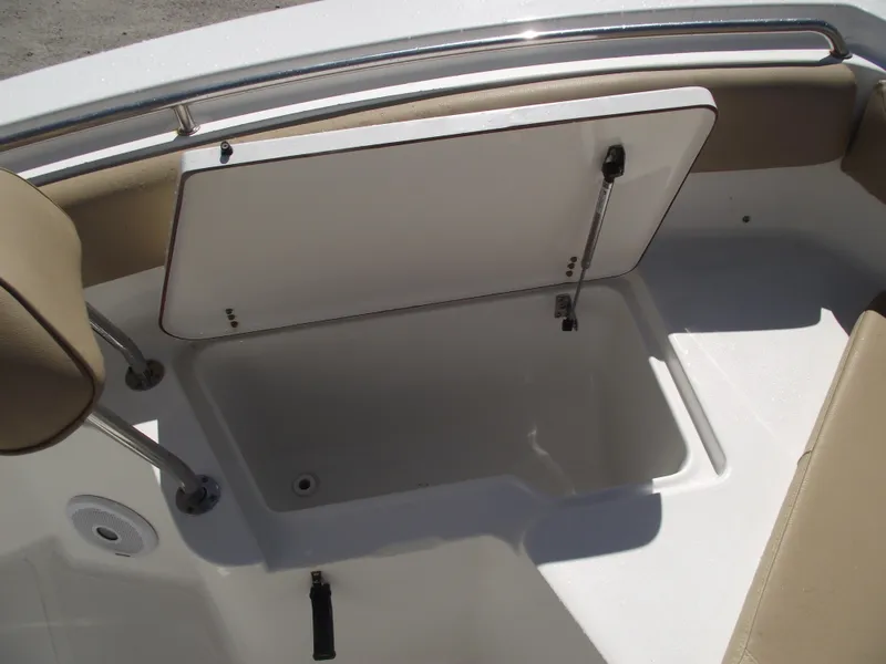 Slide: The Image of 2012 Sea Hunt Ultra 211 boat storage compartment with open lid. - 9