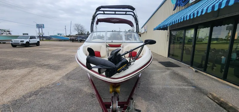 Slide: The Image of 2014 Tahoe Q5i boat on trailer outside a marine shop. - 5