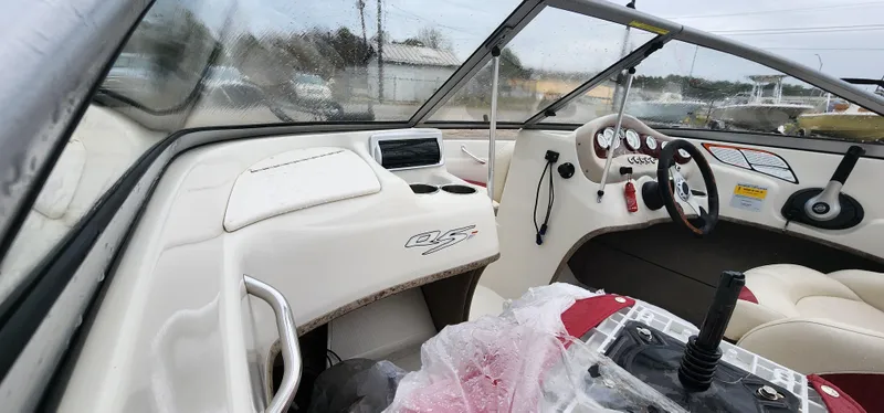 Slide: The Image of Interior of a 2014 Tahoe Q5i boat, featuring steering wheel and dashboard controls. - 9