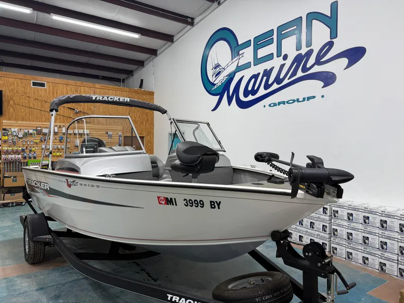 Slide: The Image of 2018 Tracker Pro Guide V 165 WT boat displayed indoors at Ocean Marine Group. - 7