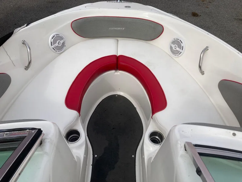 Slide: The Image of 2011 Sea Ray 205 Sport boat interior with red and white seating. - 11