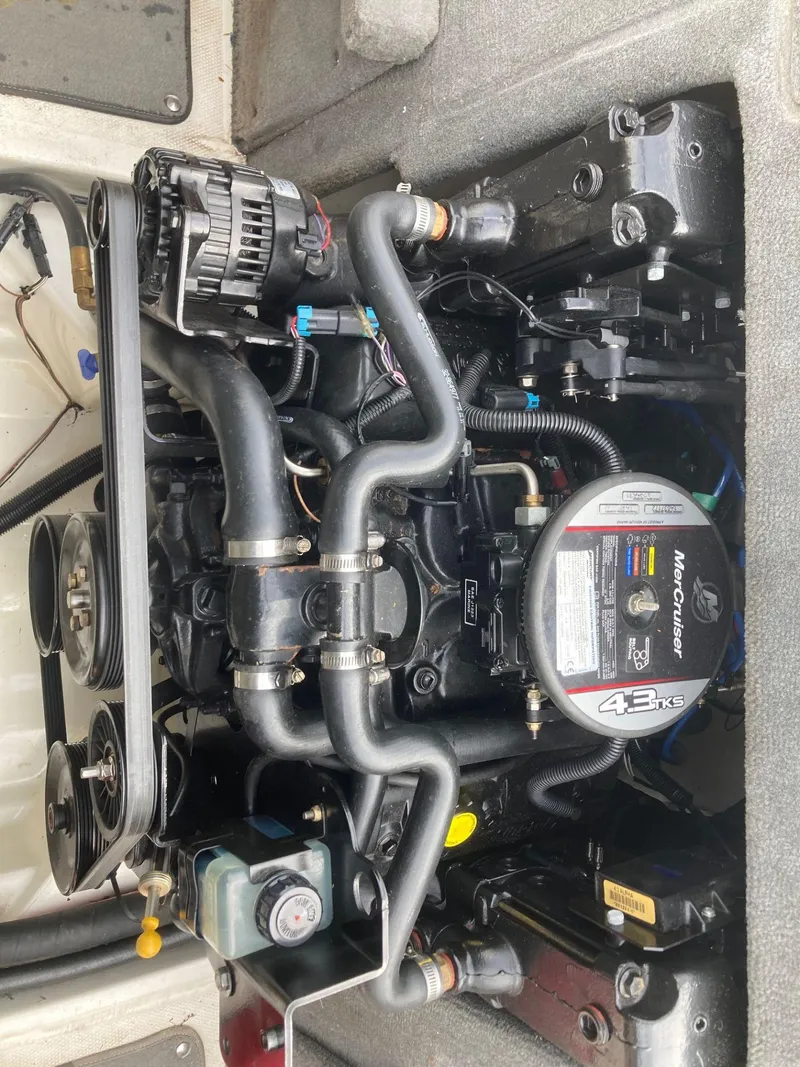 Slide: The Image of 2011 Sea Ray 205 Sport engine compartment showcasing MerCruiser 4.3L V6 engine components. - 12