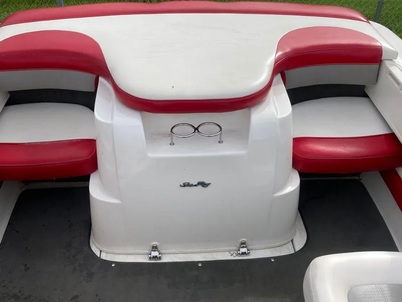 Slide: The Image of 2011 Sea Ray 205 Sport boat interior with red and white seating. - 13