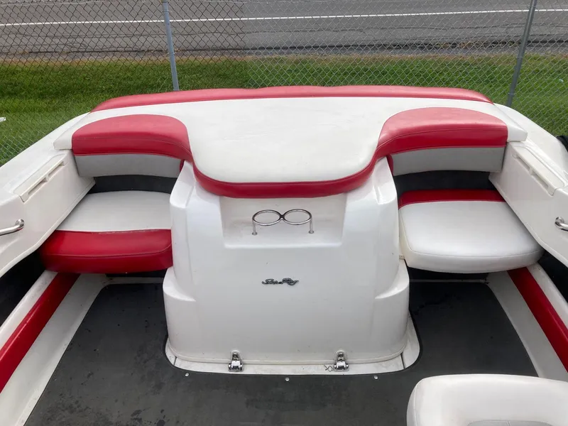 Slide: The Image of 2011 Sea Ray 205 Sport boat interior with red and white seating. - 5