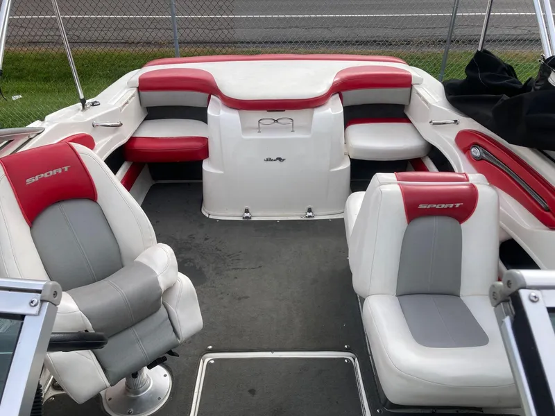 Slide: The Image of 2011 Sea Ray 205 Sport boat interior with red and white seating, showcasing spacious design. - 6