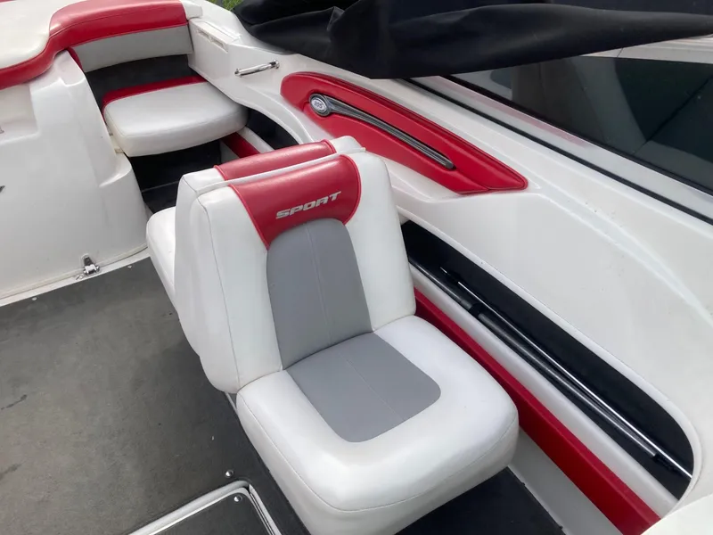 Slide: The Image of 2011 Sea Ray 205 Sport boat interior with red and white seating. - 7