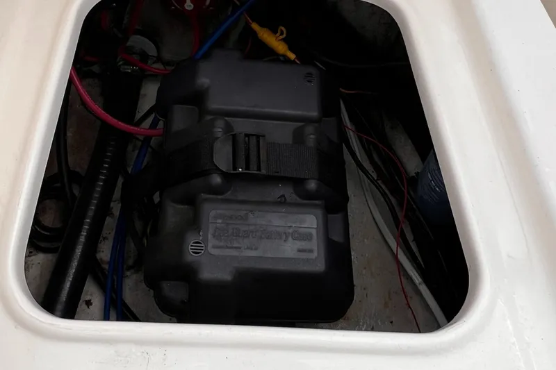 Slide: The Image of Battery compartment of a 2003 Sea Hunt Triton 202 boat with wiring. - 2