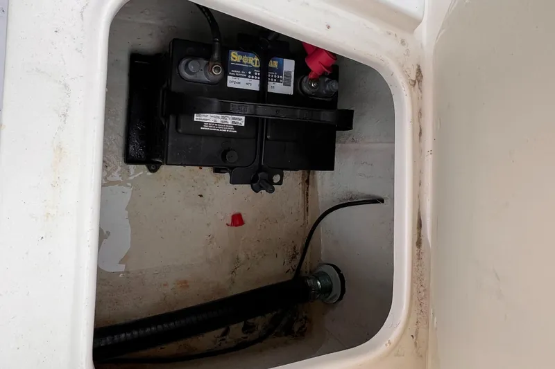 Slide: The Image of Battery compartment of 2003 Sea Hunt Triton 202 boat, showing wiring and connections. - 3