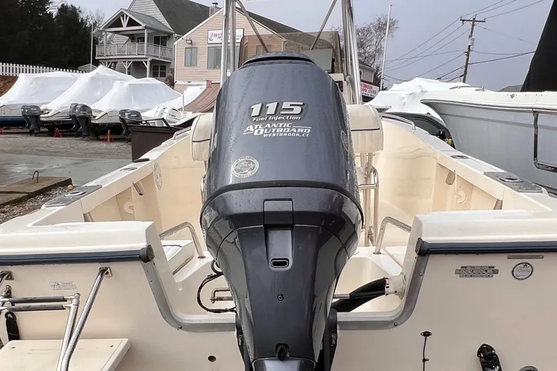 Slide: The Image of 2003 Sea Hunt Triton 202 boat with 115 horsepower outboard motor, docked outdoors. - 6