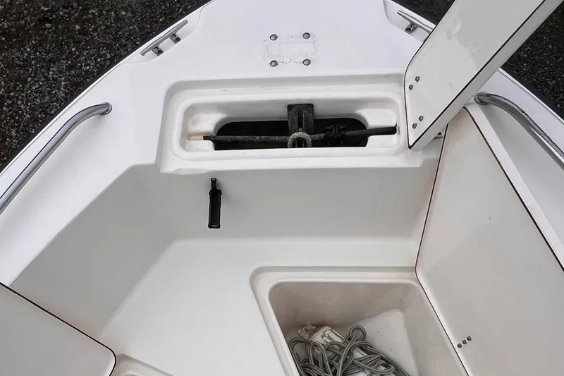 Slide: The Image of 2003 Sea Hunt Triton 202 boat anchor storage compartment with open hatch. - 7