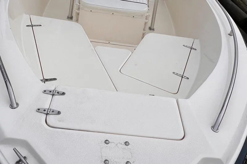 Slide: The Image of 2003 Sea Hunt Triton 202 boat deck with storage compartments. - 8