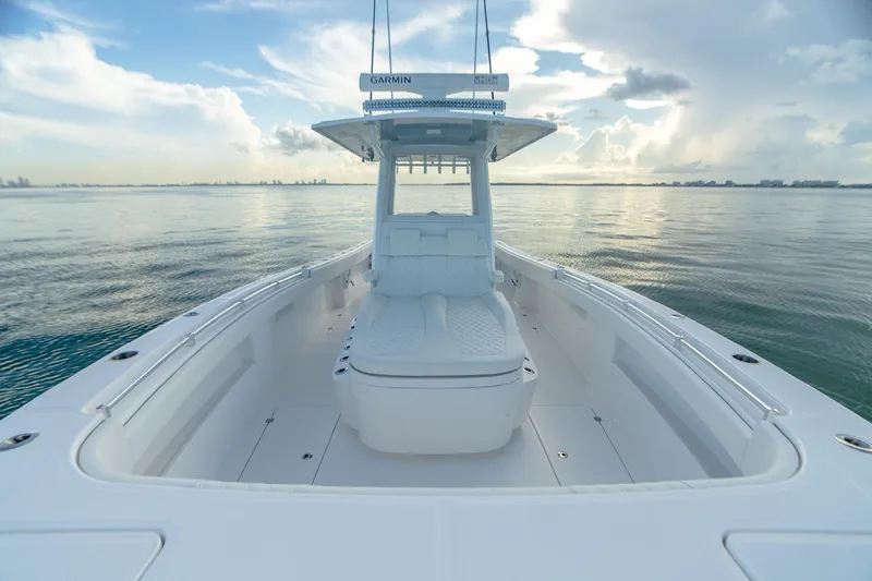 Slide: The Image of 2022 Invincible 33 Catamaran on calm water, showcasing spacious deck and modern design. - 10
