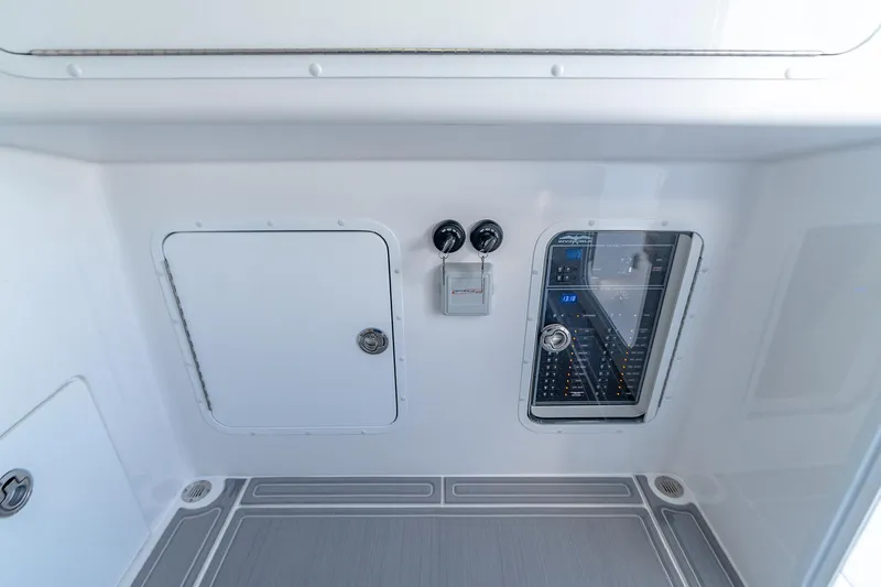 Slide: The Image of 2022 Invincible 33 Catamaran interior with control panel and storage compartments. - 13