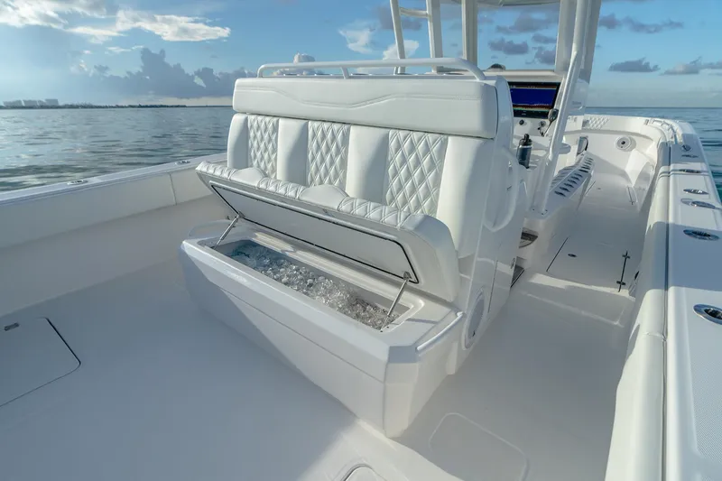Slide: The Image of 2022 Invincible 33 Catamaran with luxurious seating and storage, cruising on calm waters. - 15