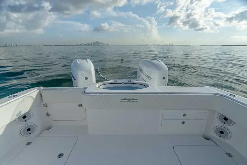 Slide: The Image of Invincible 33 Catamaran 2022 on calm ocean waters, showcasing dual engines and spacious deck. - 17
