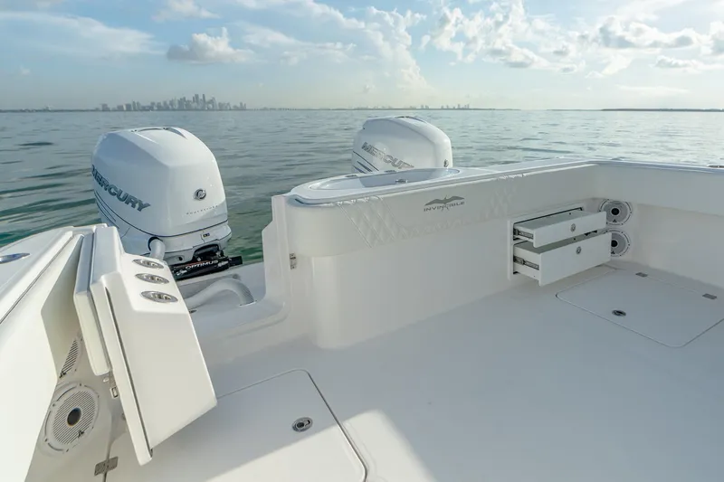 Slide: The Image of 2022 Invincible 33 Catamaran with twin Mercury engines on calm water. - 18