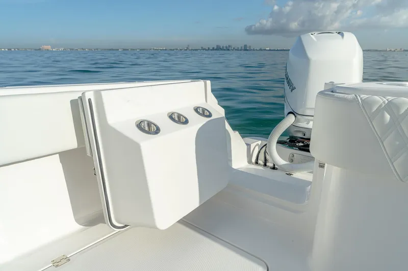 Slide: The Image of 2022 Invincible 33 Catamaran, rear deck view with ocean backdrop. - 19