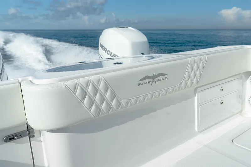 Slide: The Image of 2022 Invincible 33 Catamaran cruising on open water, showcasing sleek design and powerful engine. - 22
