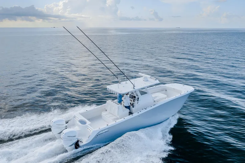 Slide: The Image of 2022 Invincible 33 Catamaran cruising on open water, showcasing sleek design and powerful engines. - 25