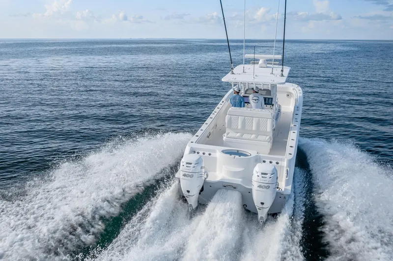 Slide: The Image of 2022 Invincible 33 Catamaran cruising on open water, showcasing powerful twin engines. - 26