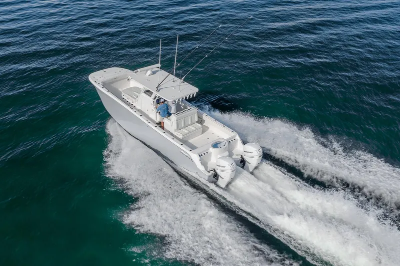 Slide: The Image of 2022 Invincible 33 Catamaran cruising on open water, showcasing sleek design and powerful engines. - 27