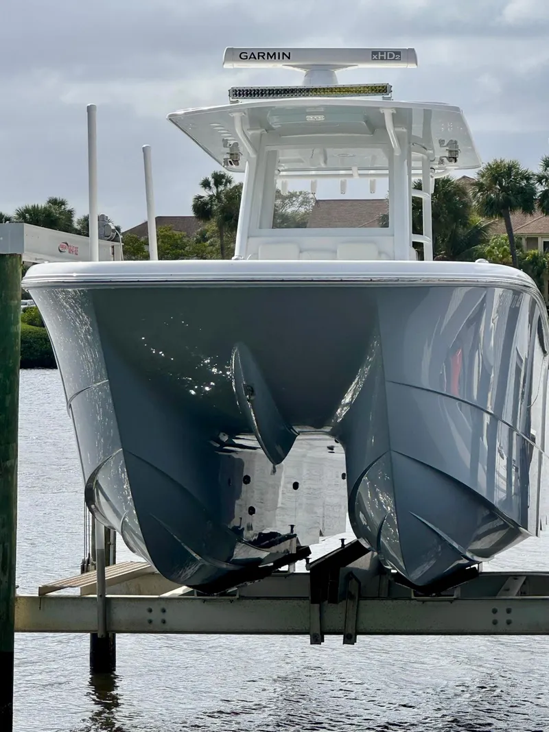 Slide: The Image of 2022 Invincible 33 Catamaran on lift, front view, with Garmin equipment. - 28
