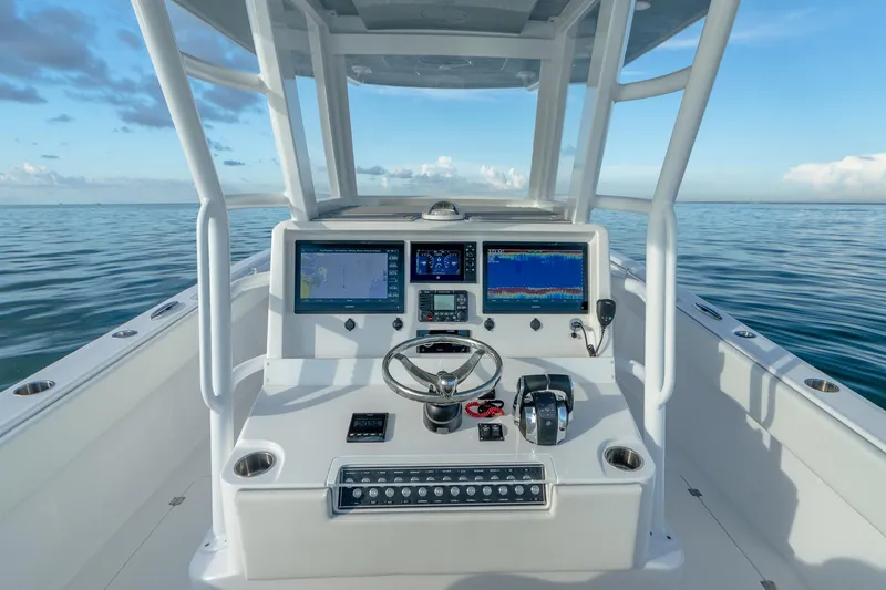 Slide: The Image of 2022 Invincible 33 Catamaran dashboard with navigation screens on calm ocean. - 3
