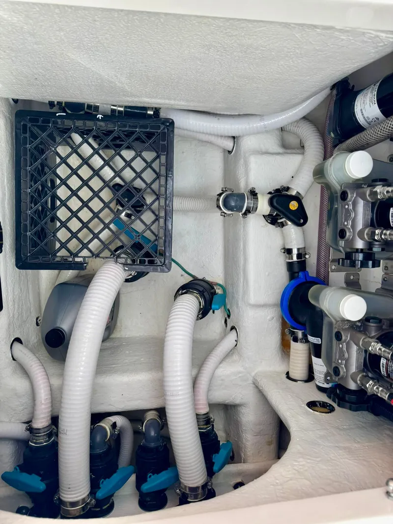 Slide: The Image of Engine compartment of 2022 Invincible 33 Catamaran with hoses and mechanical components. - 32