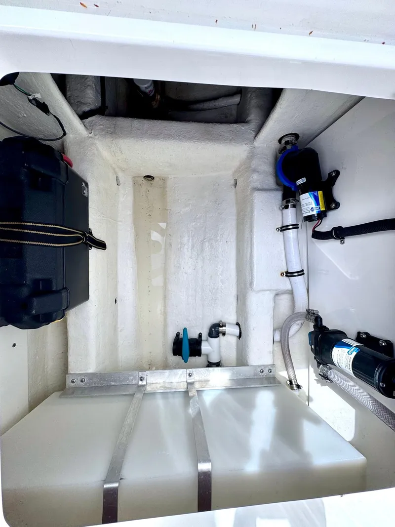 Slide: The Image of 2022 Invincible 33 Catamaran interior compartment with equipment and storage. - 34