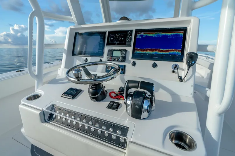 Slide: The Image of Helm of 2022 Invincible 33 Catamaran with advanced navigation and control systems. - 4