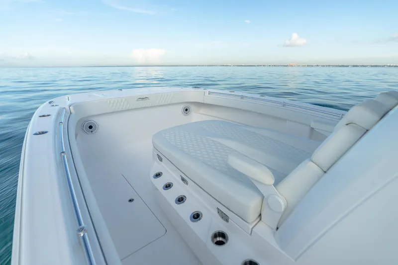 Slide: The Image of Invincible 33 Catamaran 2022, sleek white interior, calm ocean backdrop. - 6