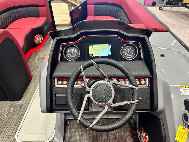 Slide: The Image of 2024 Godfrey AquaPatio 235 SFLC dashboard with steering wheel and navigation display. - 3