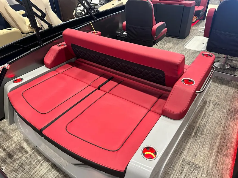 Slide: The Image of 2024 Godfrey AquaPatio 235 SFLC boat with red seating and cup holders. - 4