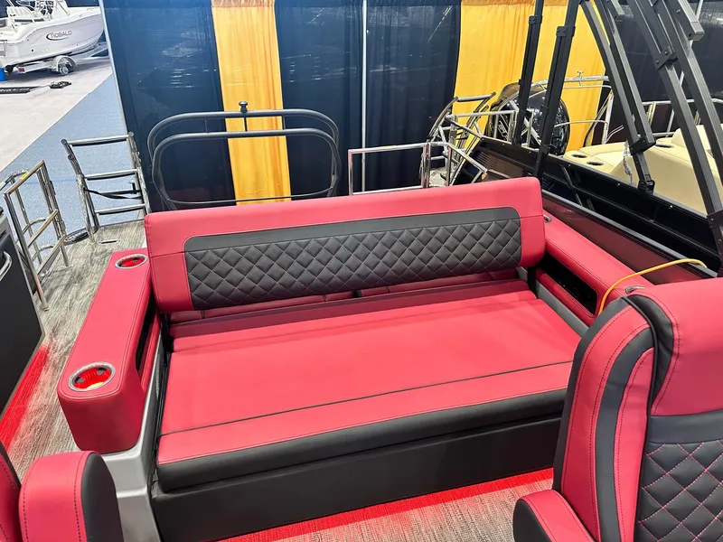 Slide: The Image of 2024 Godfrey AquaPatio 235 SFLC boat interior with red and black seating. - 5