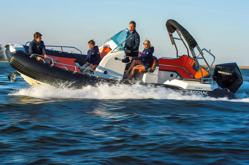 The Image of 2025 Zodiac Medline 6.8 boat cruising with passengers on open water. - 0