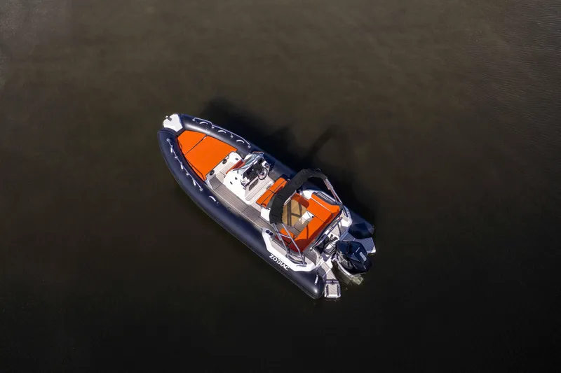Slide: The Image of 2025 Zodiac Medline 6.8 boat with orange seating, aerial view on water. - 13