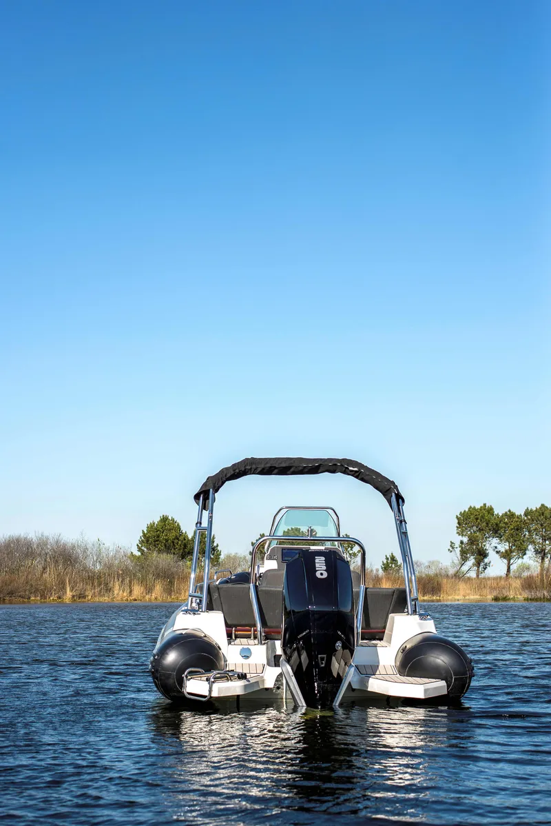 Slide: The Image of 2025 Zodiac Medline 6.8 boat on calm water under clear blue sky. - 11